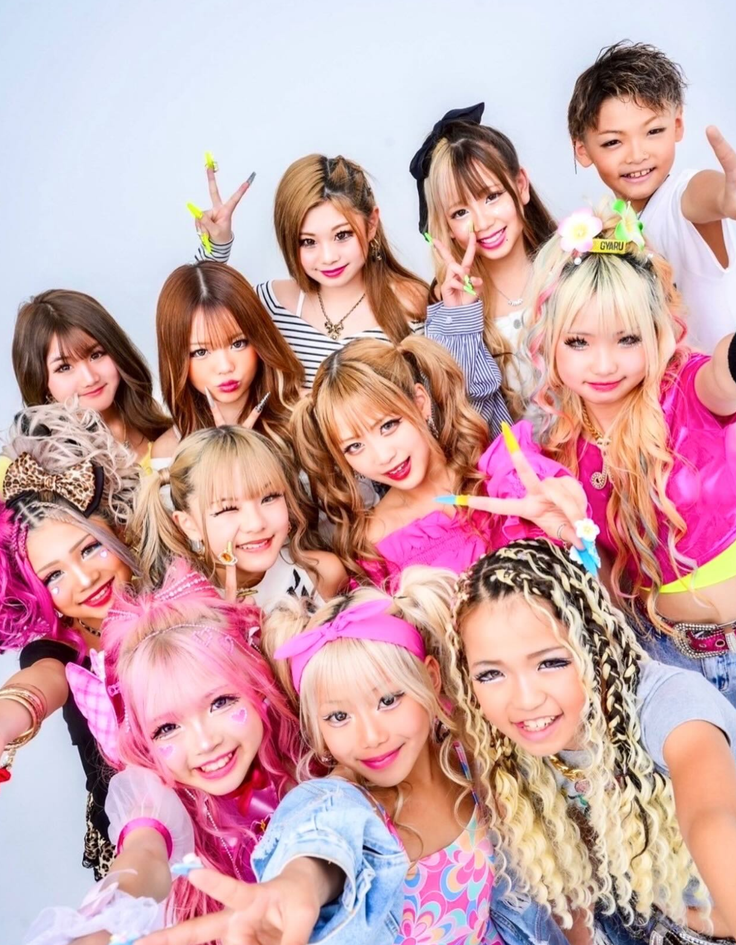 Group of people with colorful hair and bright makeup in a studio