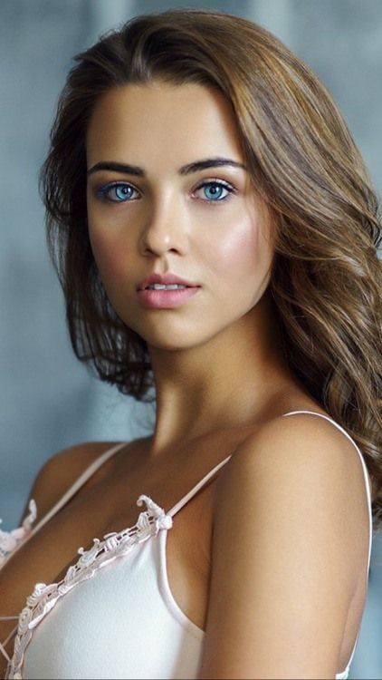 Woman with blue eyes and long hair wearing lingerie, upper body shot
