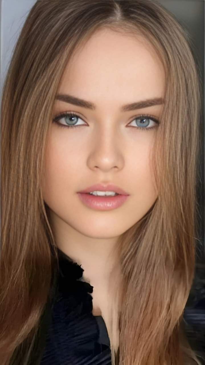 Close up portrait of a young woman with long blonde hair and blue eyes