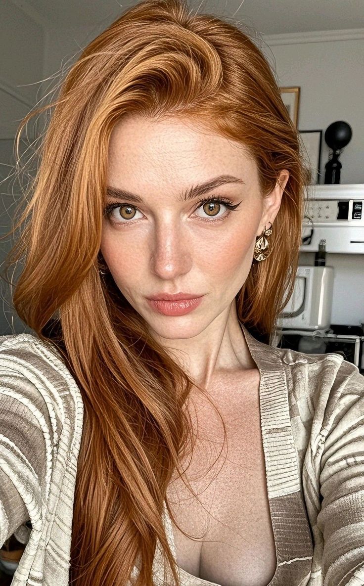 Woman with red hair and freckles wearing a striped top, showing cleavage