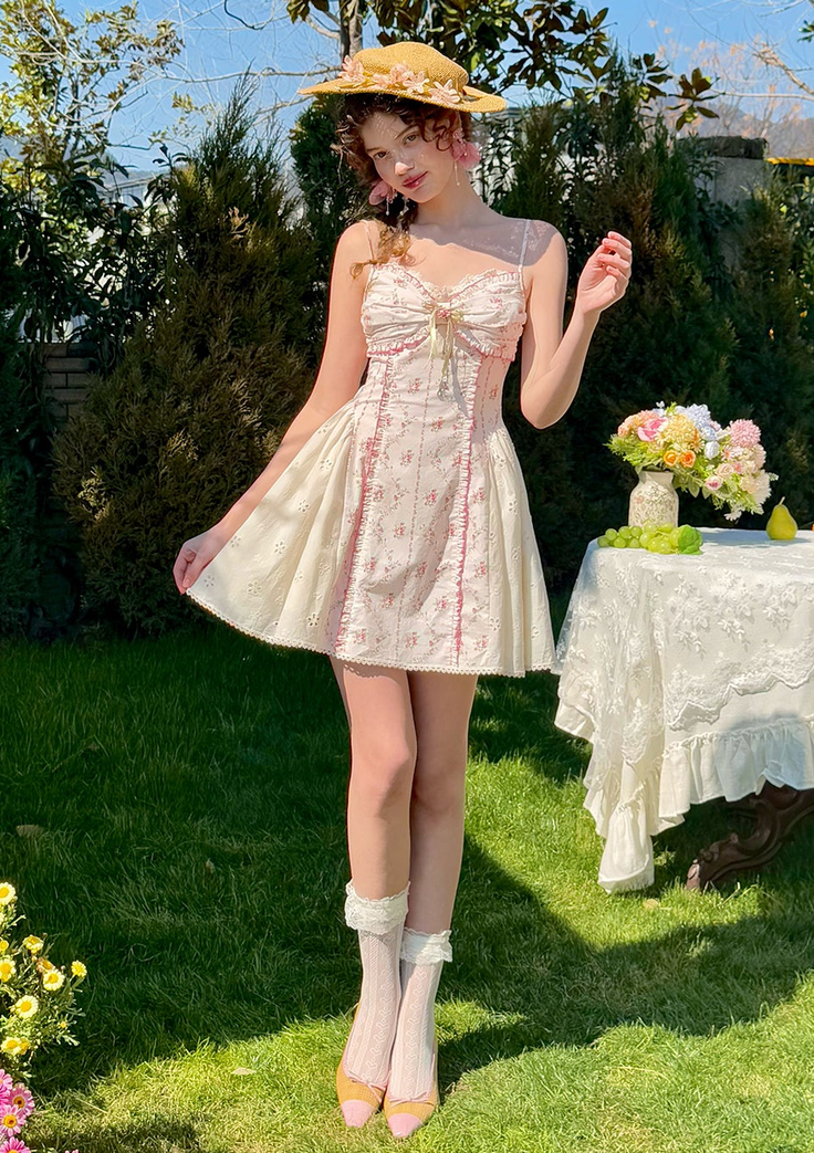 Woman in a floral dress and straw hat standing in a sunny garden