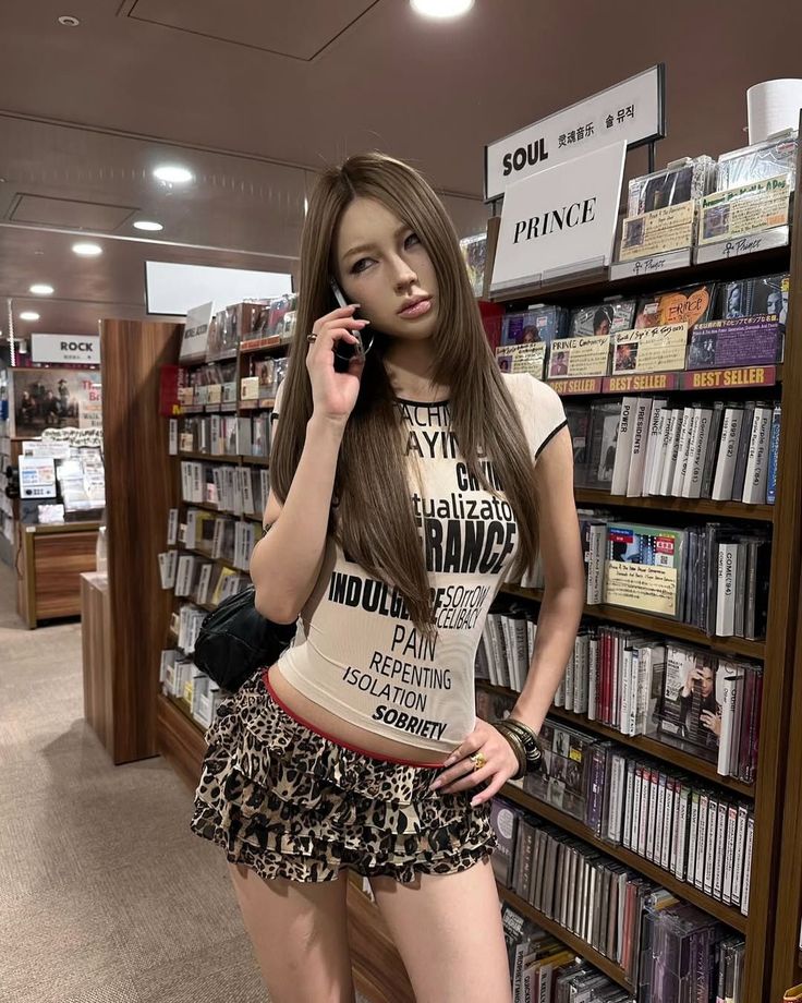 Woman with long hair in a leopard print skirt and crop top in a bookstore