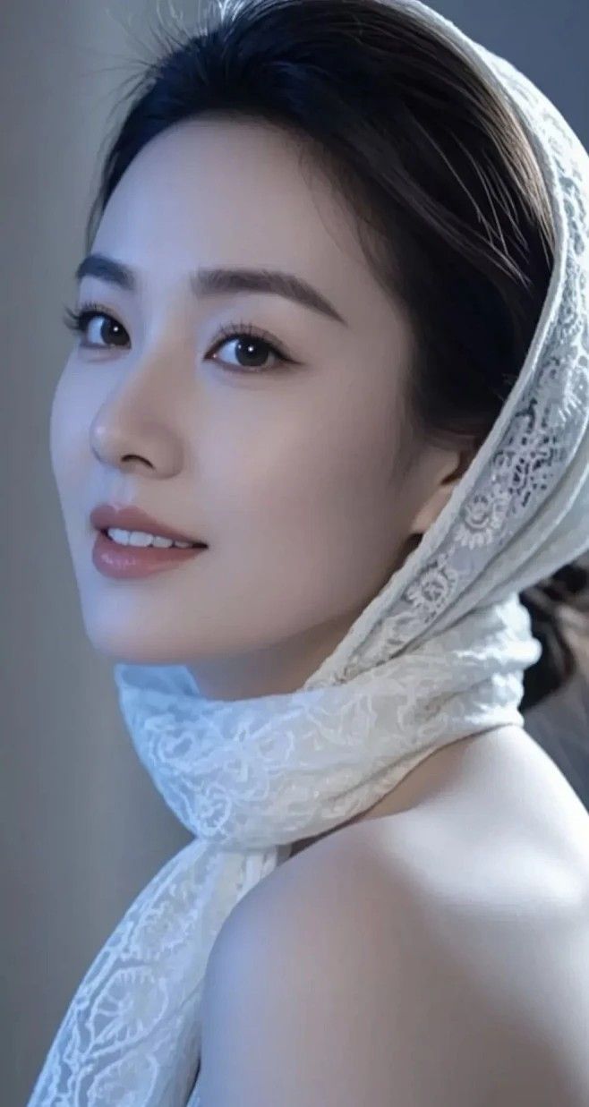 Woman with dark hair wearing a white lace headscarf and bare shoulders