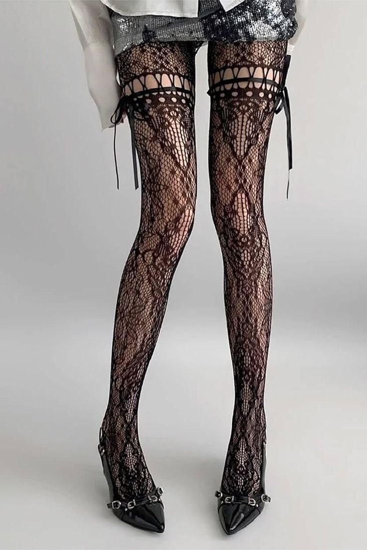 Person wearing black lace stockings with ribbons and high heels