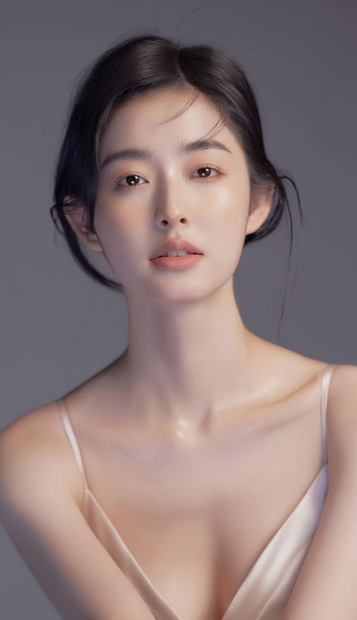 Woman with black hair and natural makeup in a studio portrait