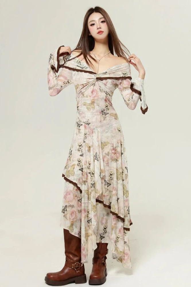 Woman in a floral off-shoulder dress and brown boots posing in a studio