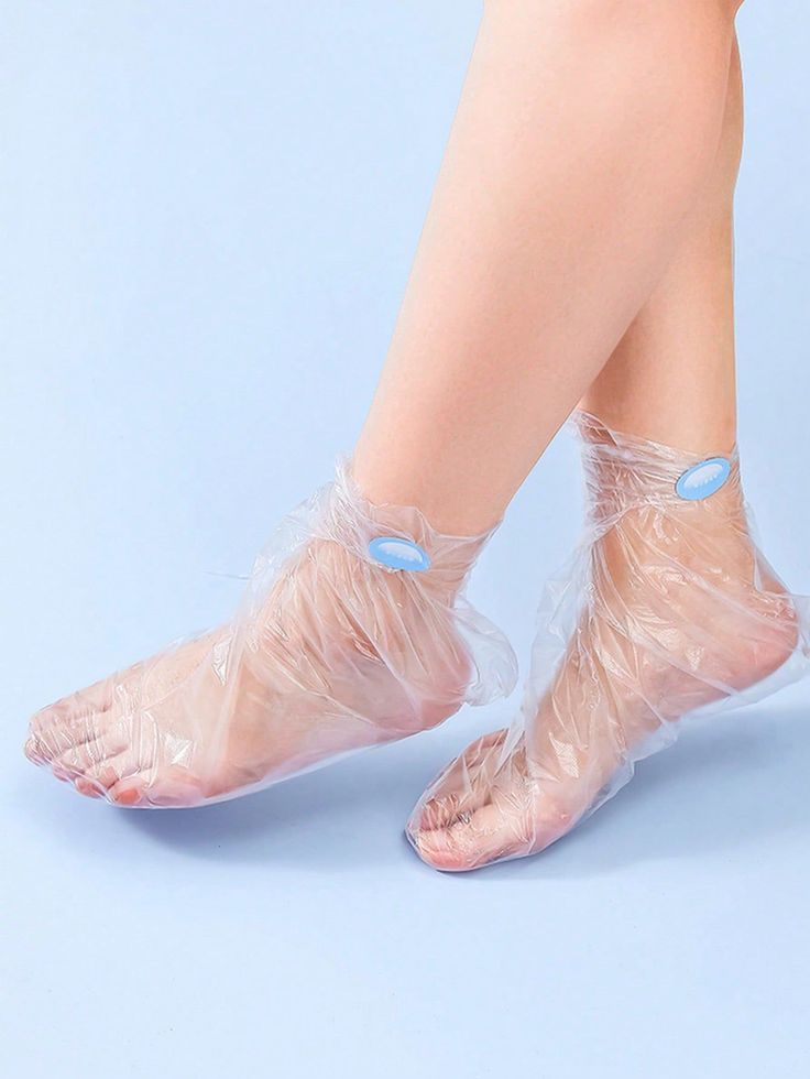 Feet wearing clear plastic foot masks with blue tabs on a light blue background