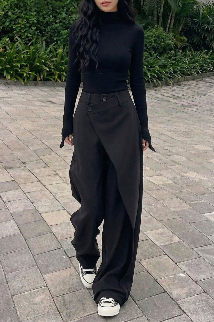 Woman in a black turtleneck and wide leg pants walking outdoors