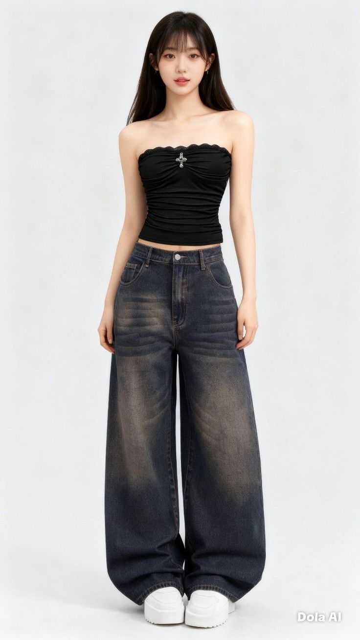 Woman in a black tube top and wide leg jeans on a white background