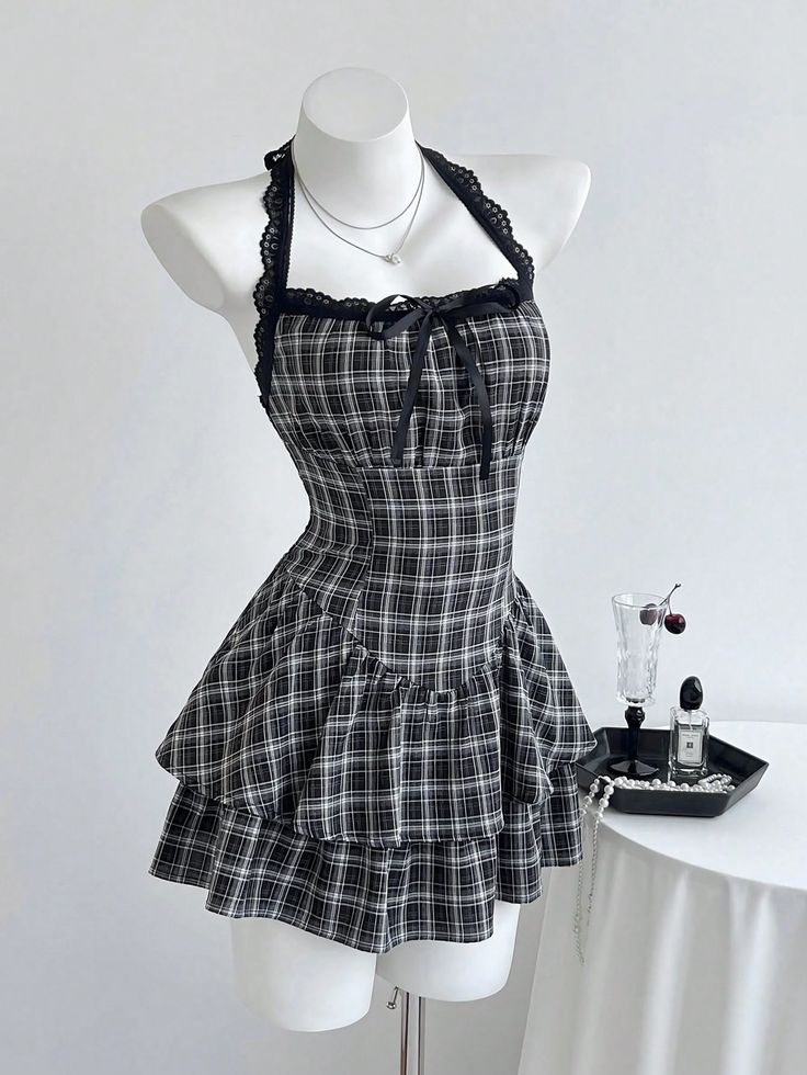 Plaid halter neck dress with lace trim and ruffle skirt on a mannequin