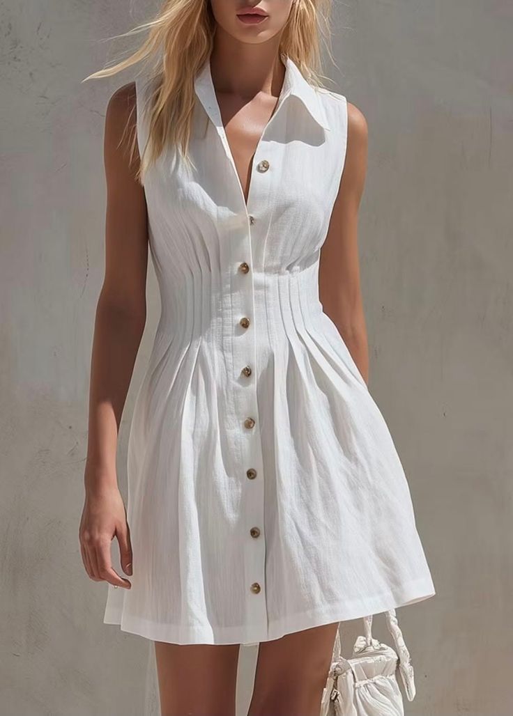 Woman in a white sleeveless collared dress with blonde hair outdoors