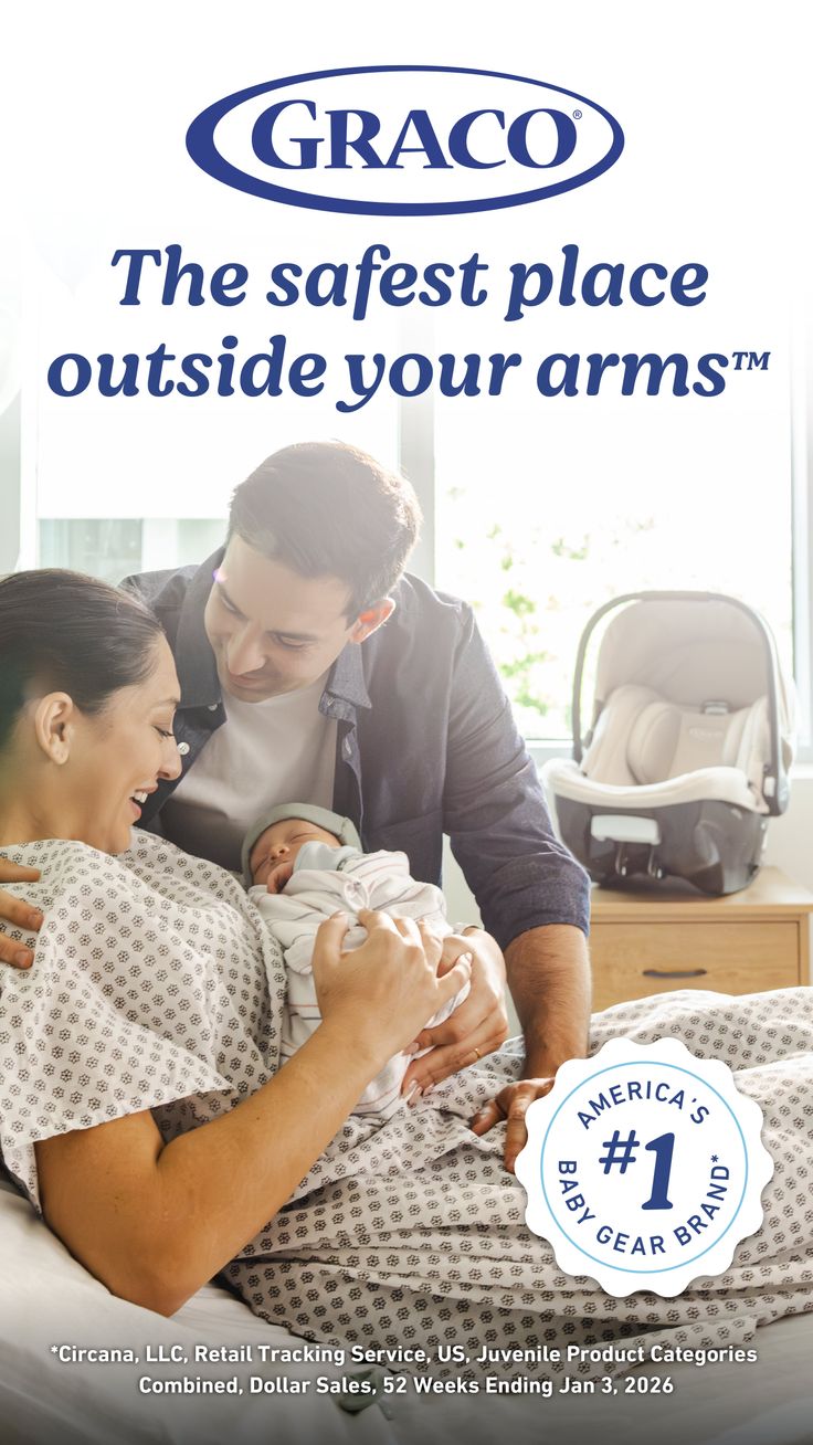 Parents with their newborn baby in a hospital room with a car seat nearby