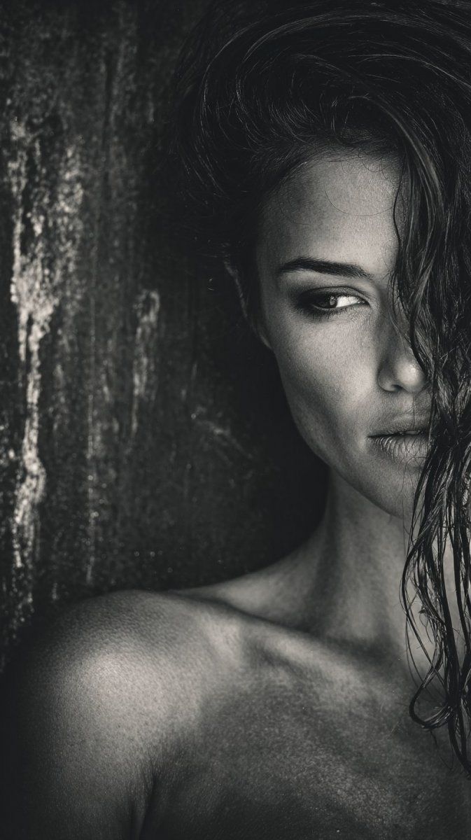 Black and white portrait of a woman with wet hair and exposed skin