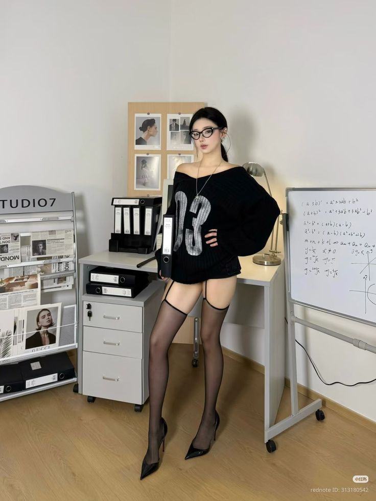 Woman in a black sweater, stockings, and high heels in an office setting