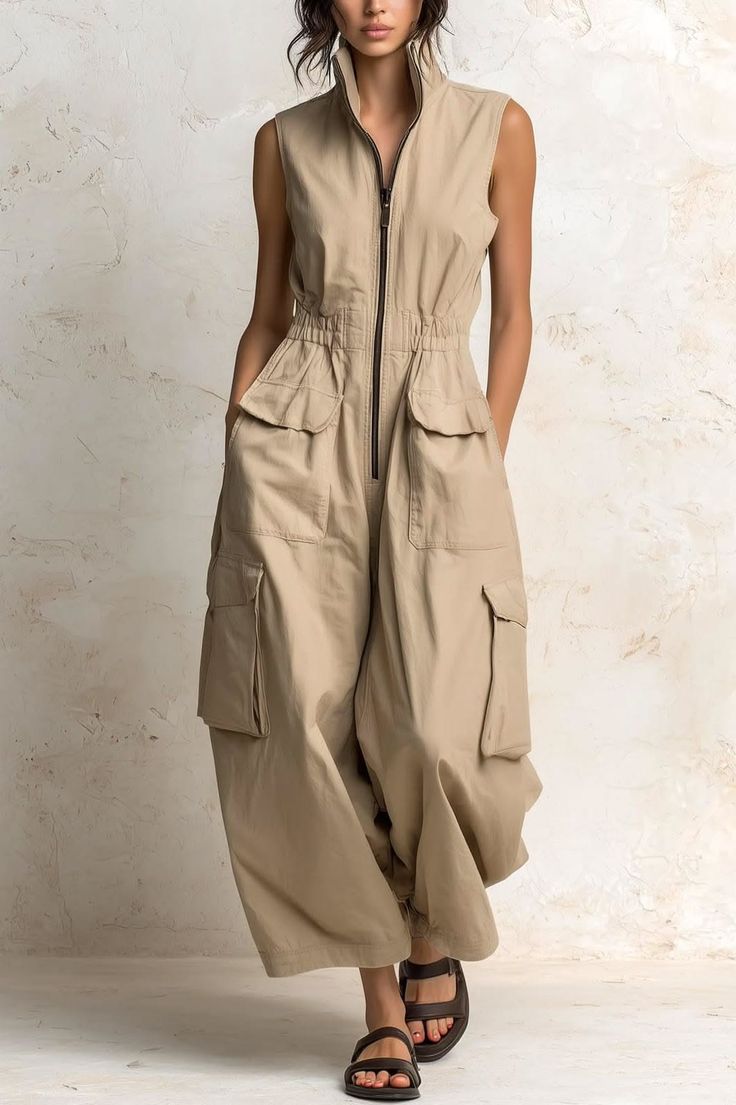 Woman in a beige sleeveless jumpsuit with cargo pockets and sandals