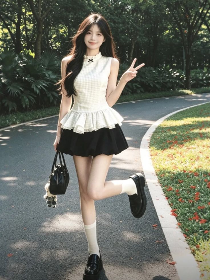 Woman in a sleeveless top and mini skirt posing outdoors with a peace sign