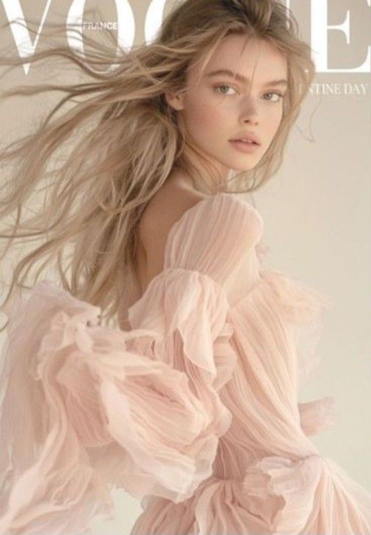 Woman with blonde hair in a ruffled pink dress with an exposed shoulder