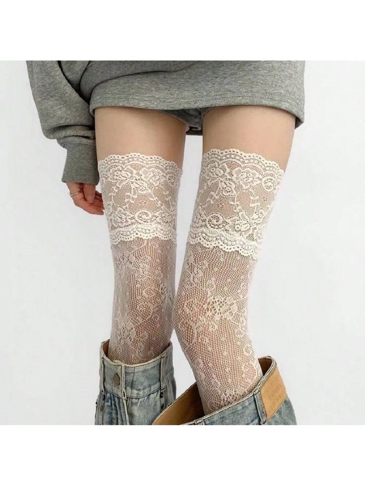 Person wearing white lace thigh-high stockings and denim shorts