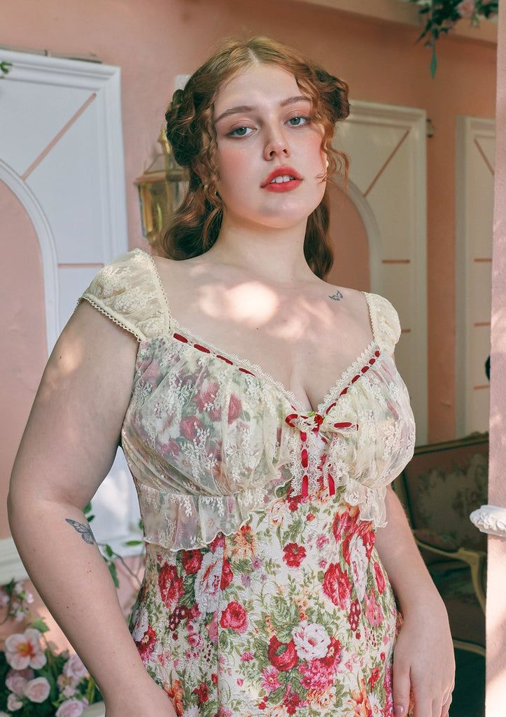 Woman with red hair in a floral dress with lace trim and red ribbons