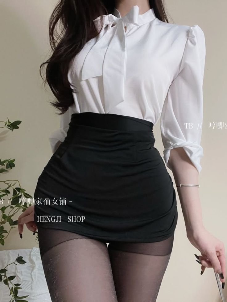 Woman in a white blouse and black skirt with pantyhose, upper body shot