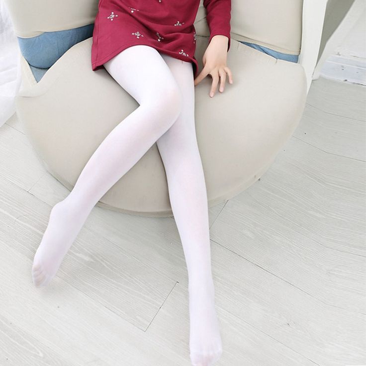 Person in a red dress and white tights sitting on a chair