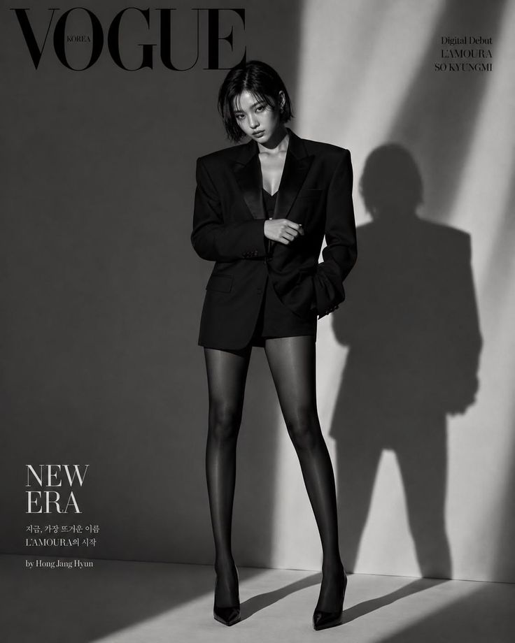 Woman in a suit jacket, shorts, and tights posing for a Vogue cover