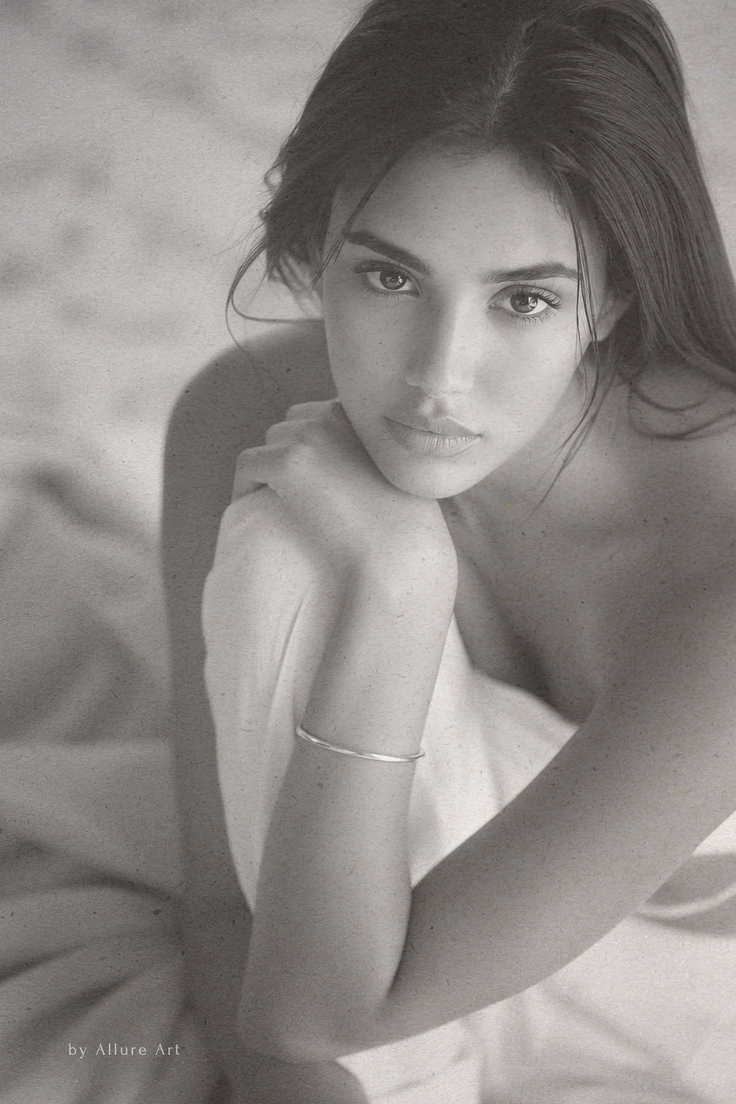 Monochrome portrait of a woman with long hair and a silver bracelet