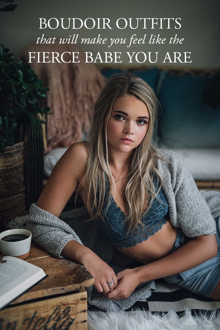 Woman in a bra and cardigan posing indoors with soft lighting