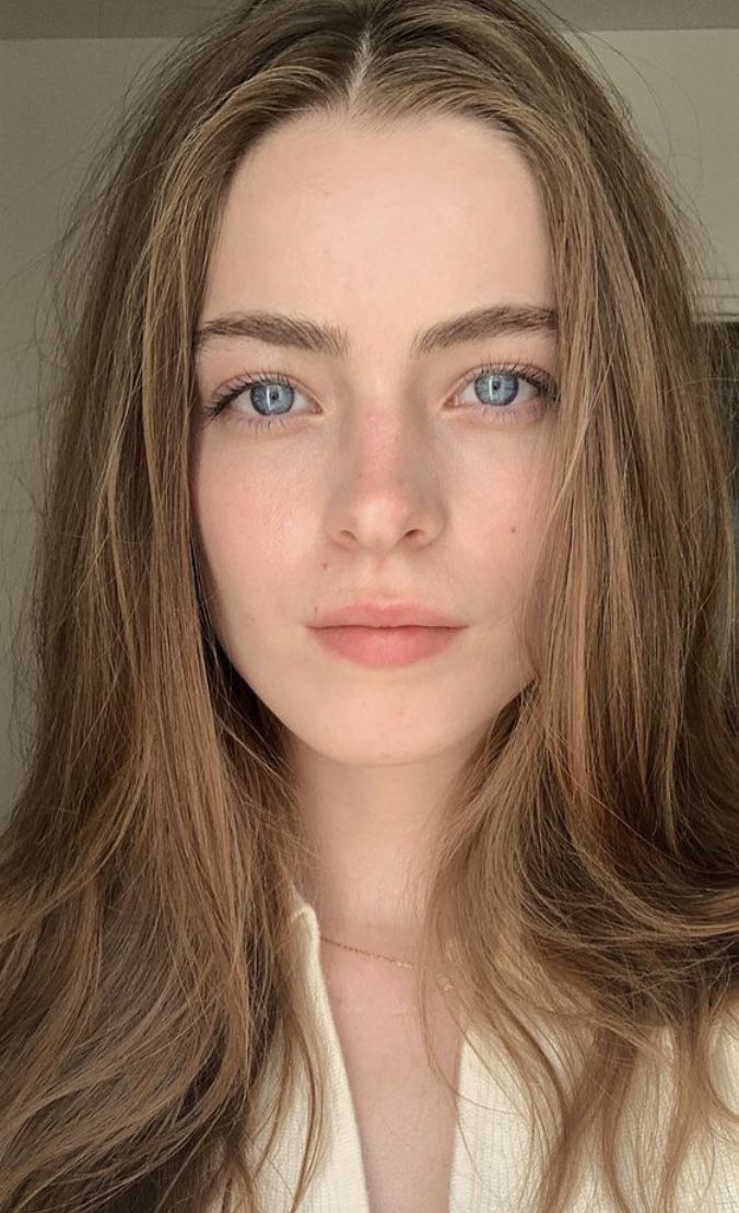 Close up portrait of a woman with blue eyes and long brown hair