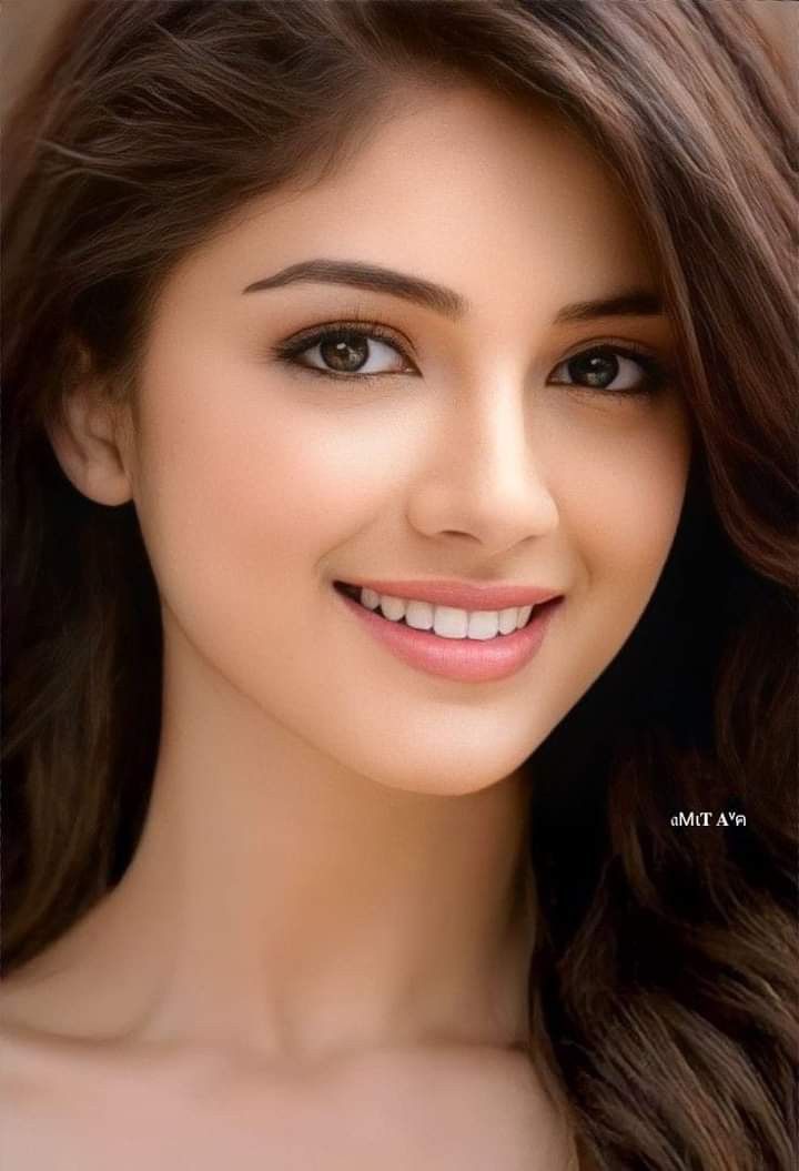 Smiling woman with long brown hair in a close-up portrait