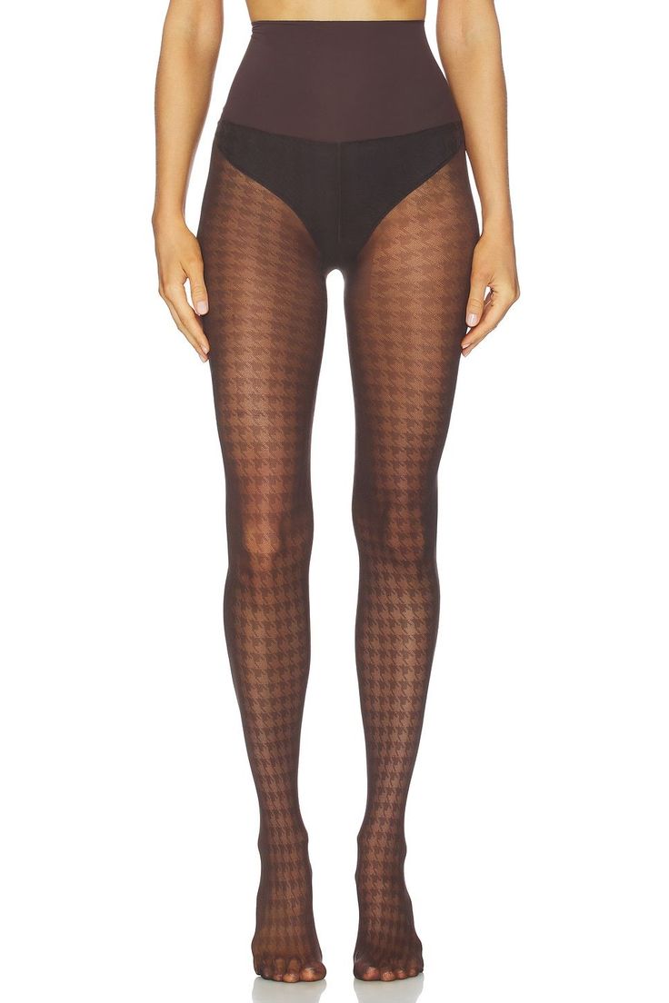 Person wearing houndstooth pattern tights and high-waisted underwear