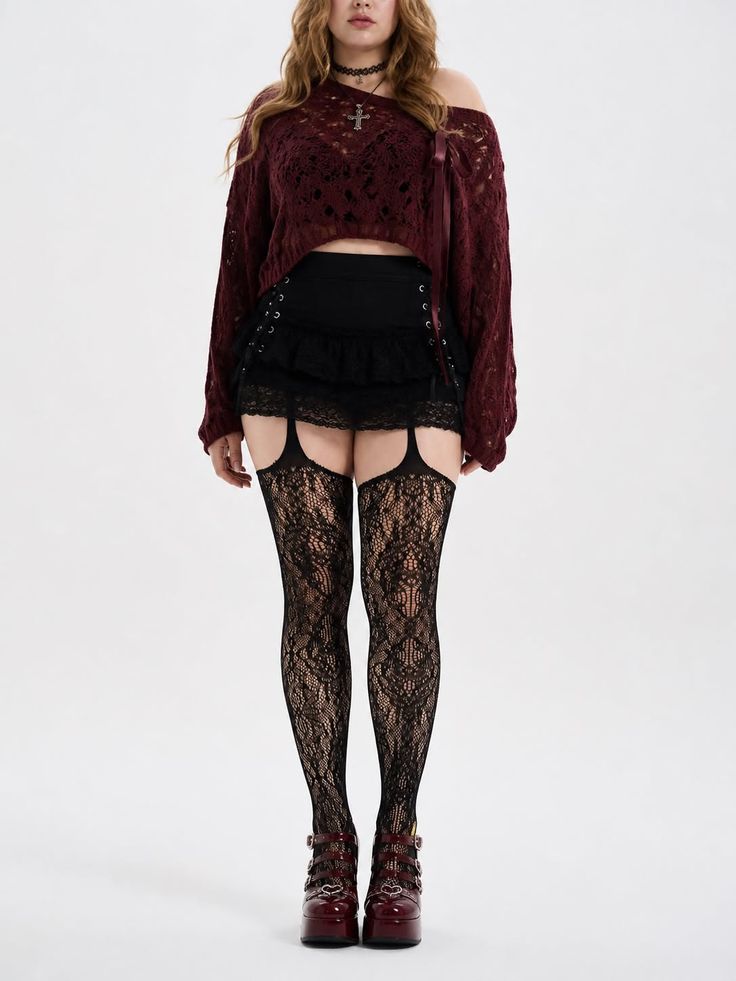 Woman in gothic-style clothing with lace stockings and a cropped sweater