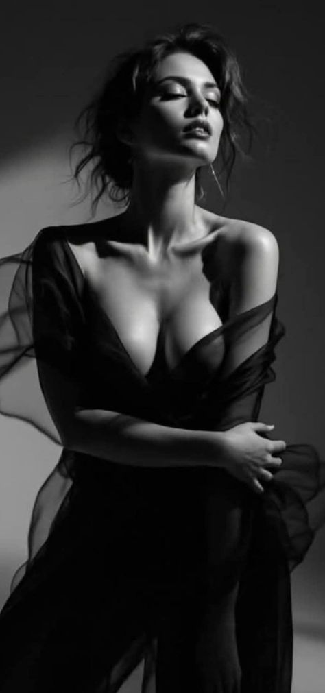 Woman in sheer fabric with dramatic lighting in black and white