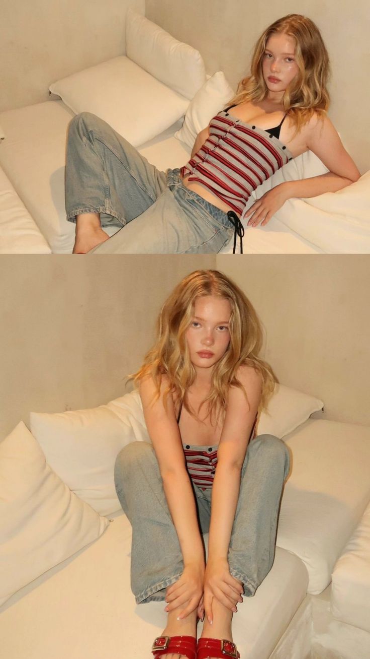 Woman with blonde hair wearing a striped top and jeans indoors