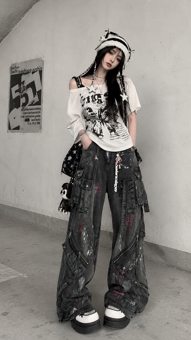 Woman in baggy jeans and a striped hat posing in an urban setting
