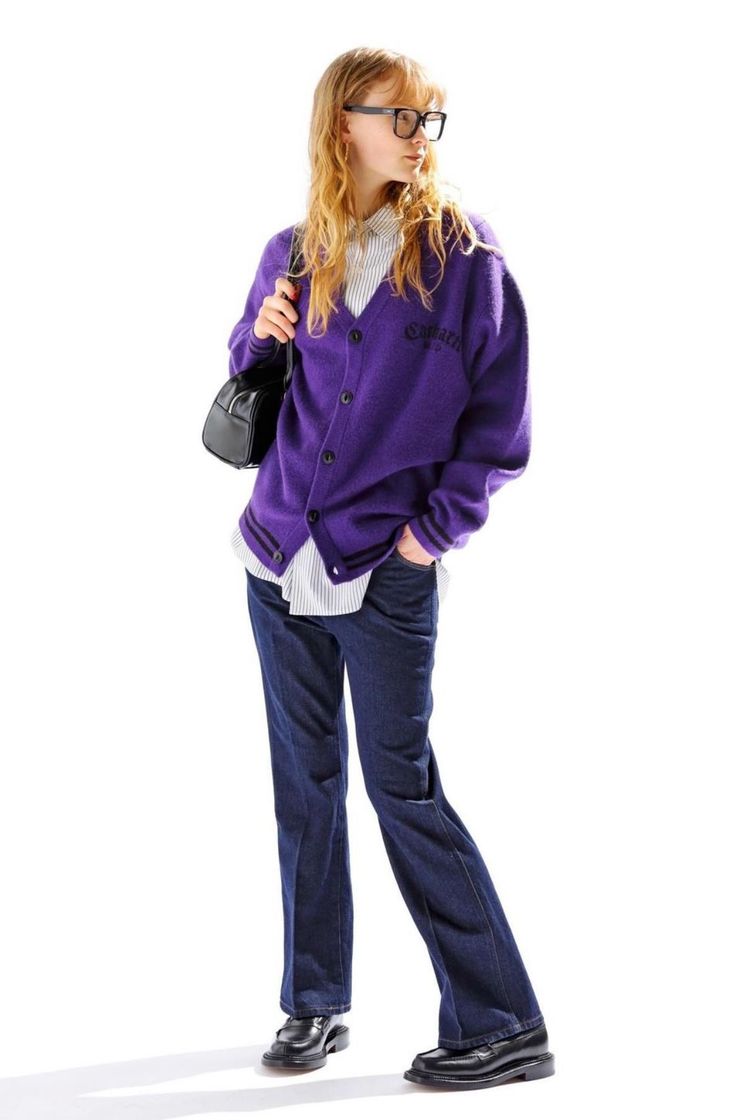 Woman in a purple cardigan, jeans, and glasses on a white background