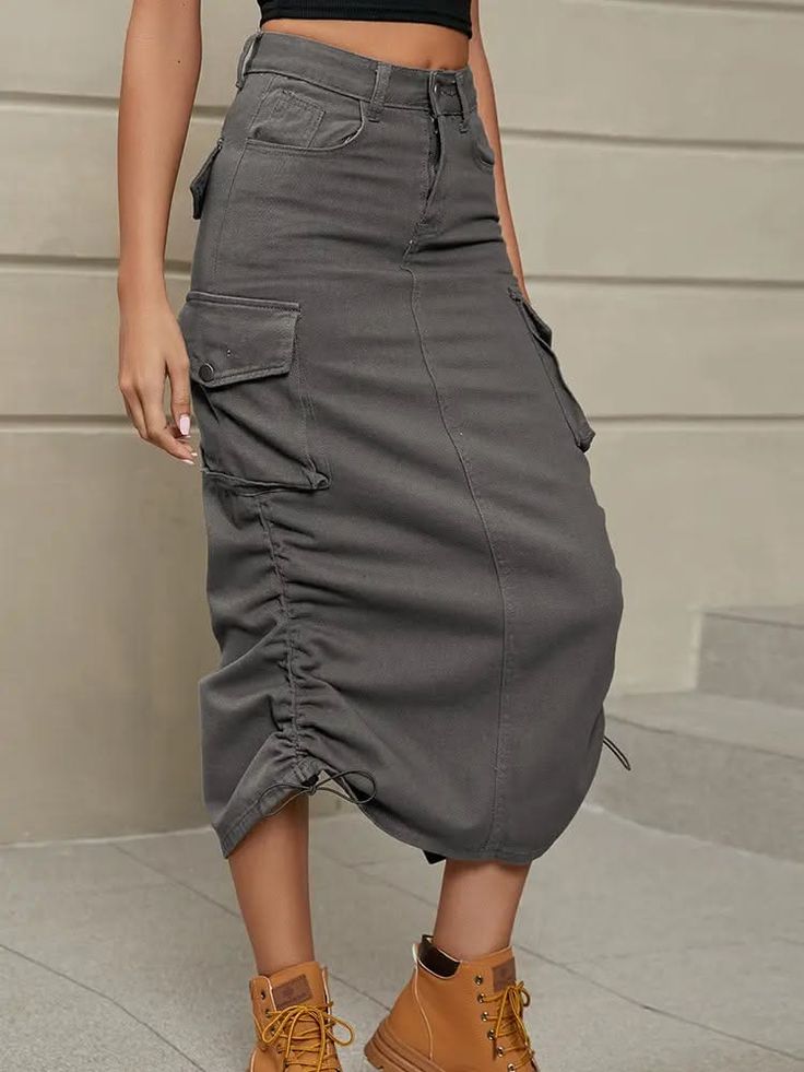 Woman wearing a gray cargo midi skirt with drawstrings and brown boots