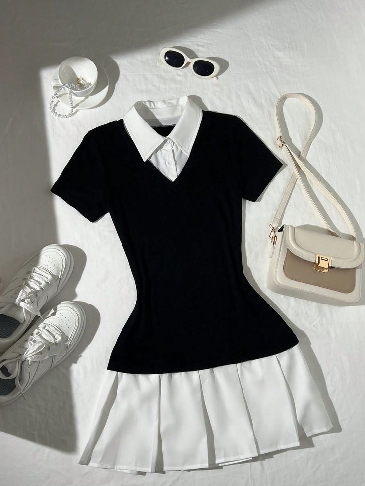 Black and white dress with accessories laid flat on a white surface
