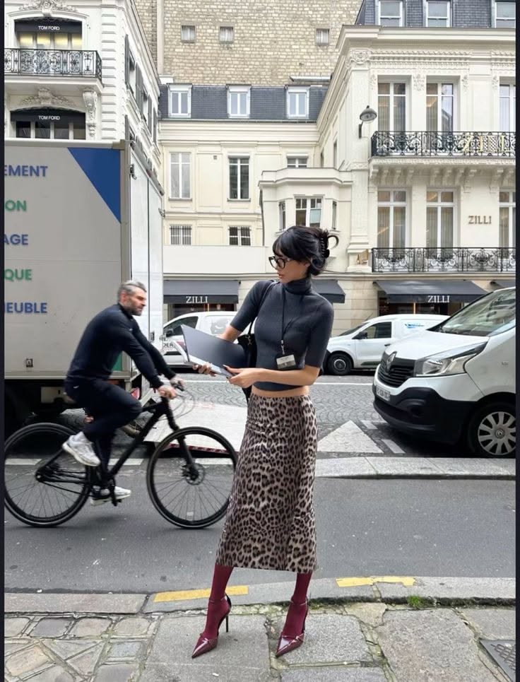 Woman in a leopard print skirt and cropped top on a city street