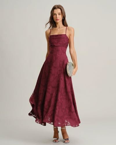 Woman in a maroon dress and strappy heels holding a clutch bag
