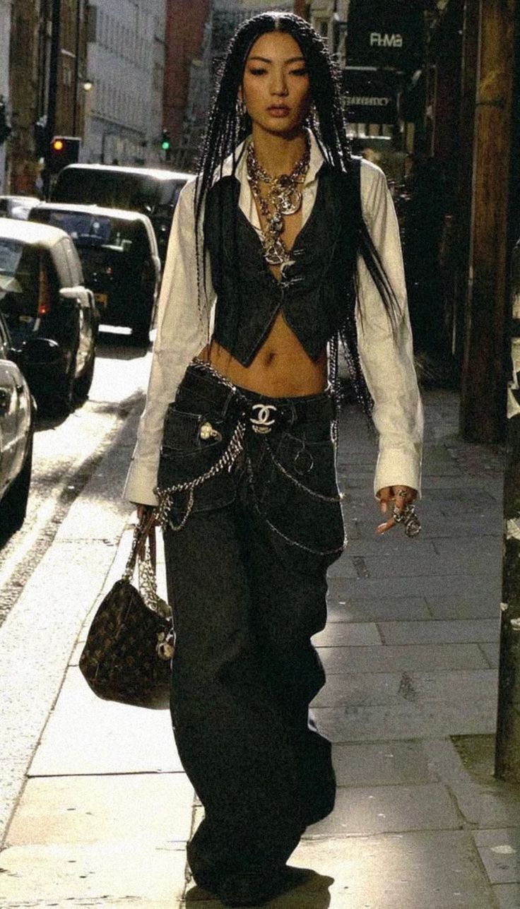 Woman with braided hair in streetwear walking on an urban street