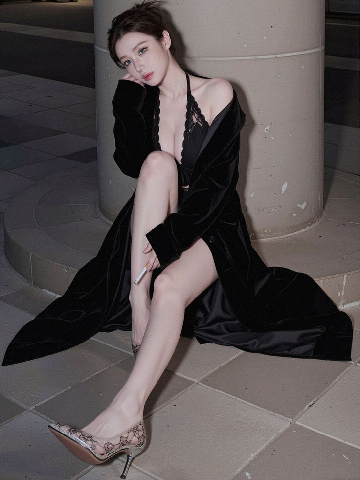 Woman in black lingerie and velvet robe with a cigarette, sitting indoors