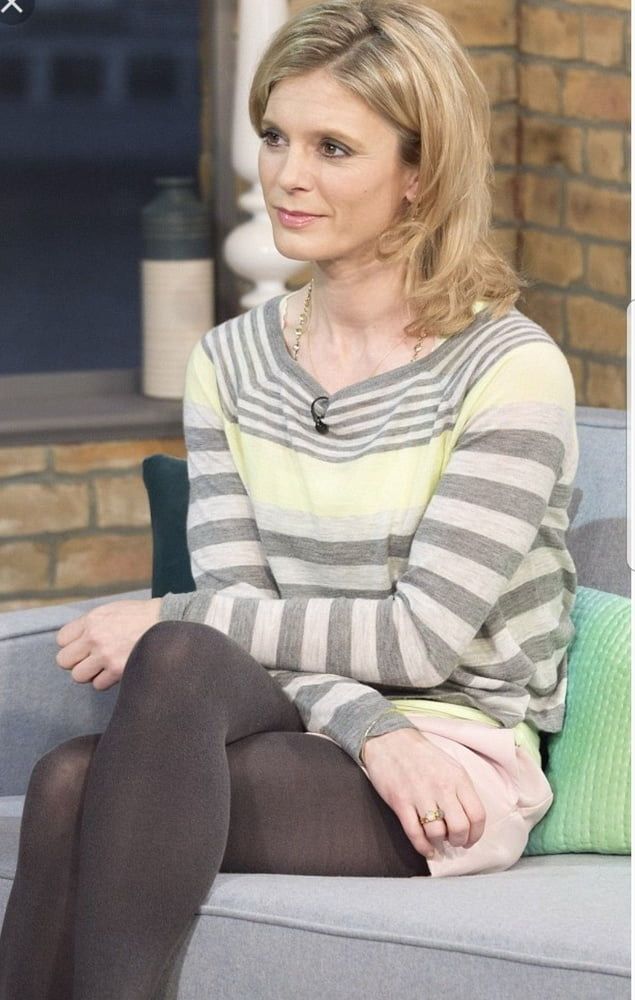 Woman with blonde hair wearing a striped long-sleeve shirt and tights, sitting indoors