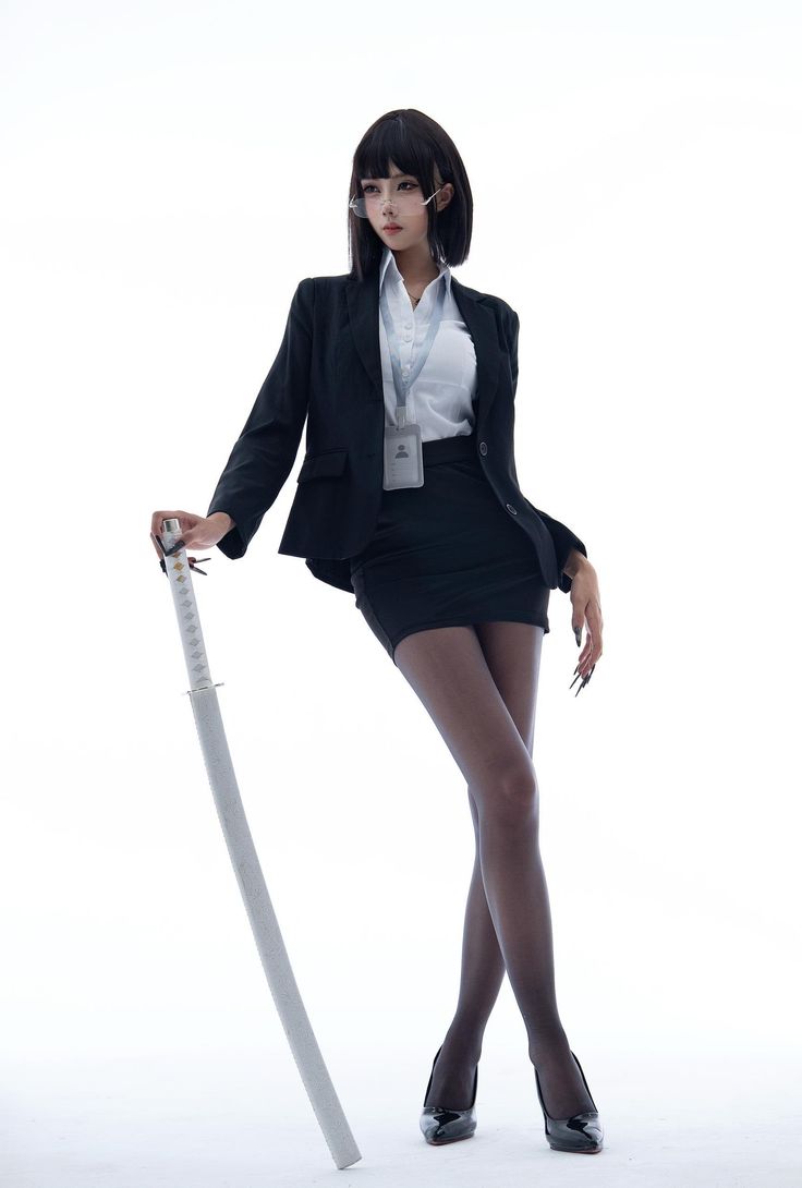 Woman in a black suit and mini skirt holding a katana on a white background