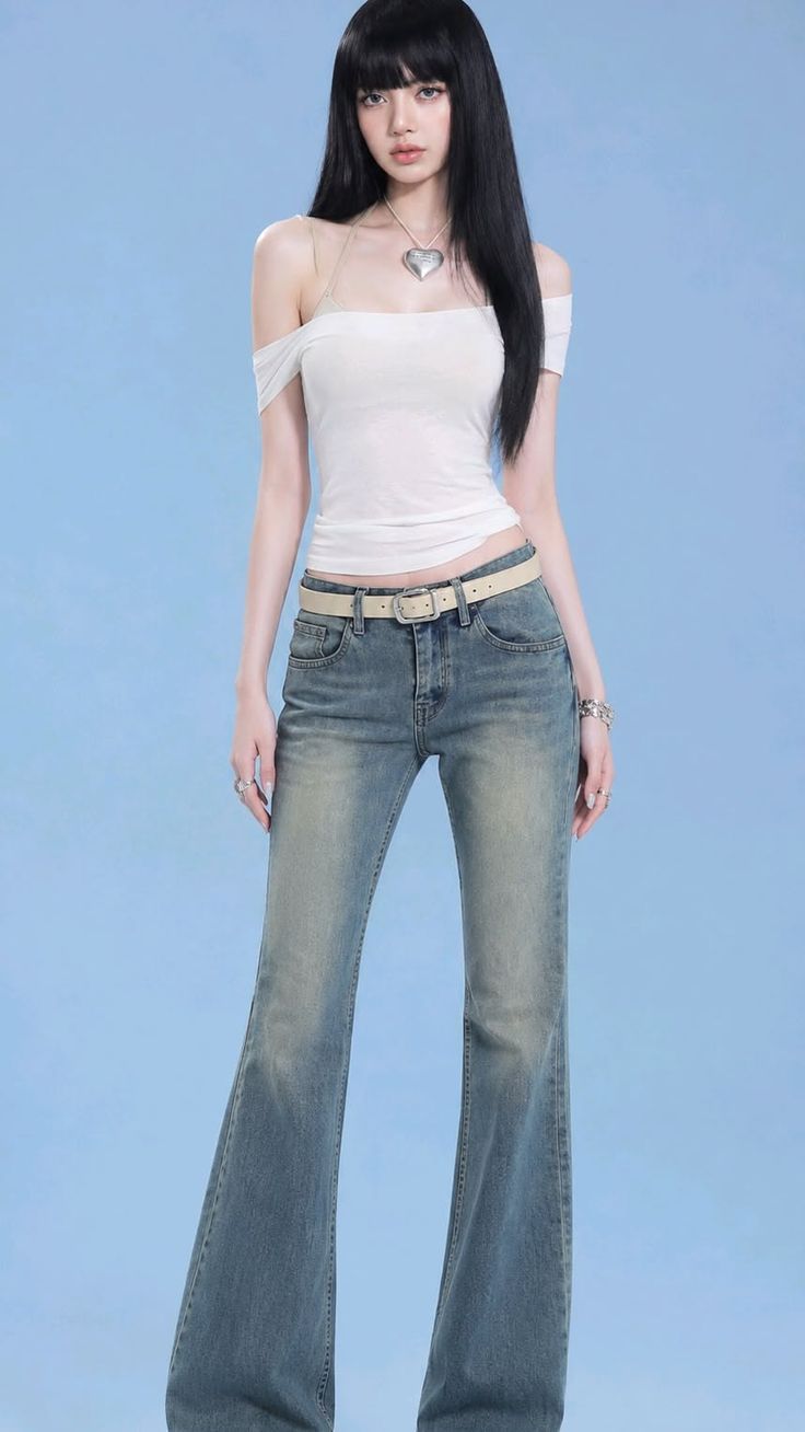 Woman with long black hair wearing an off-shoulder top and flared jeans