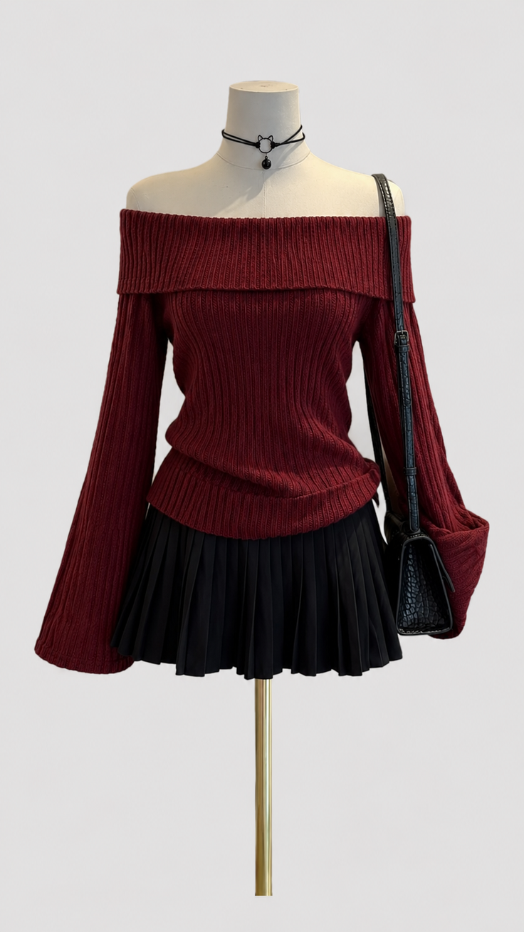 Mannequin wearing a red off-shoulder top, black pleated skirt, and choker