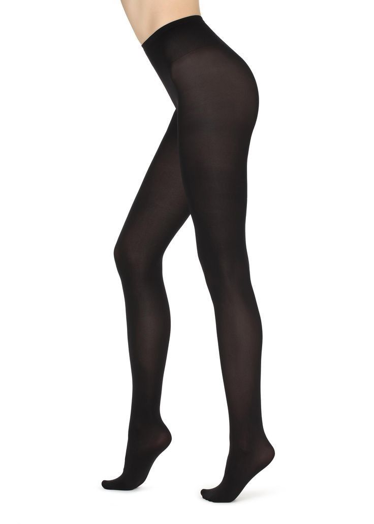 Person wearing black tights against a white background