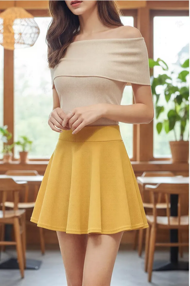 Woman in an off-shoulder top and yellow skirt indoors