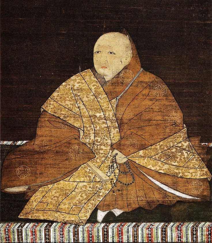 Traditional Japanese painting of a monk in a brown and gold patterned robe holding prayer beads