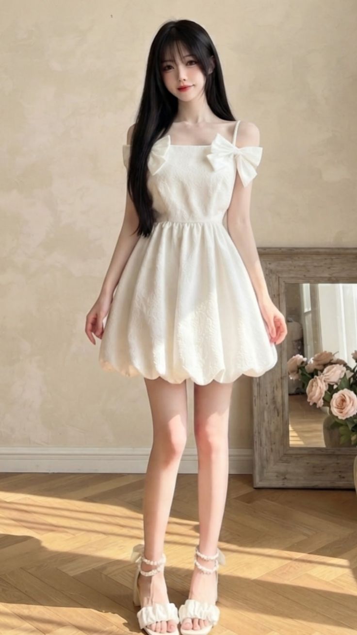 Woman in a white dress with bows and ruffled sandals indoors